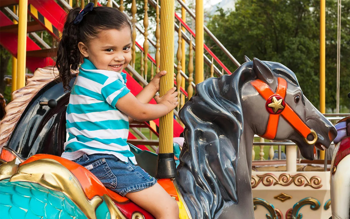 Crealy girl on merry go round